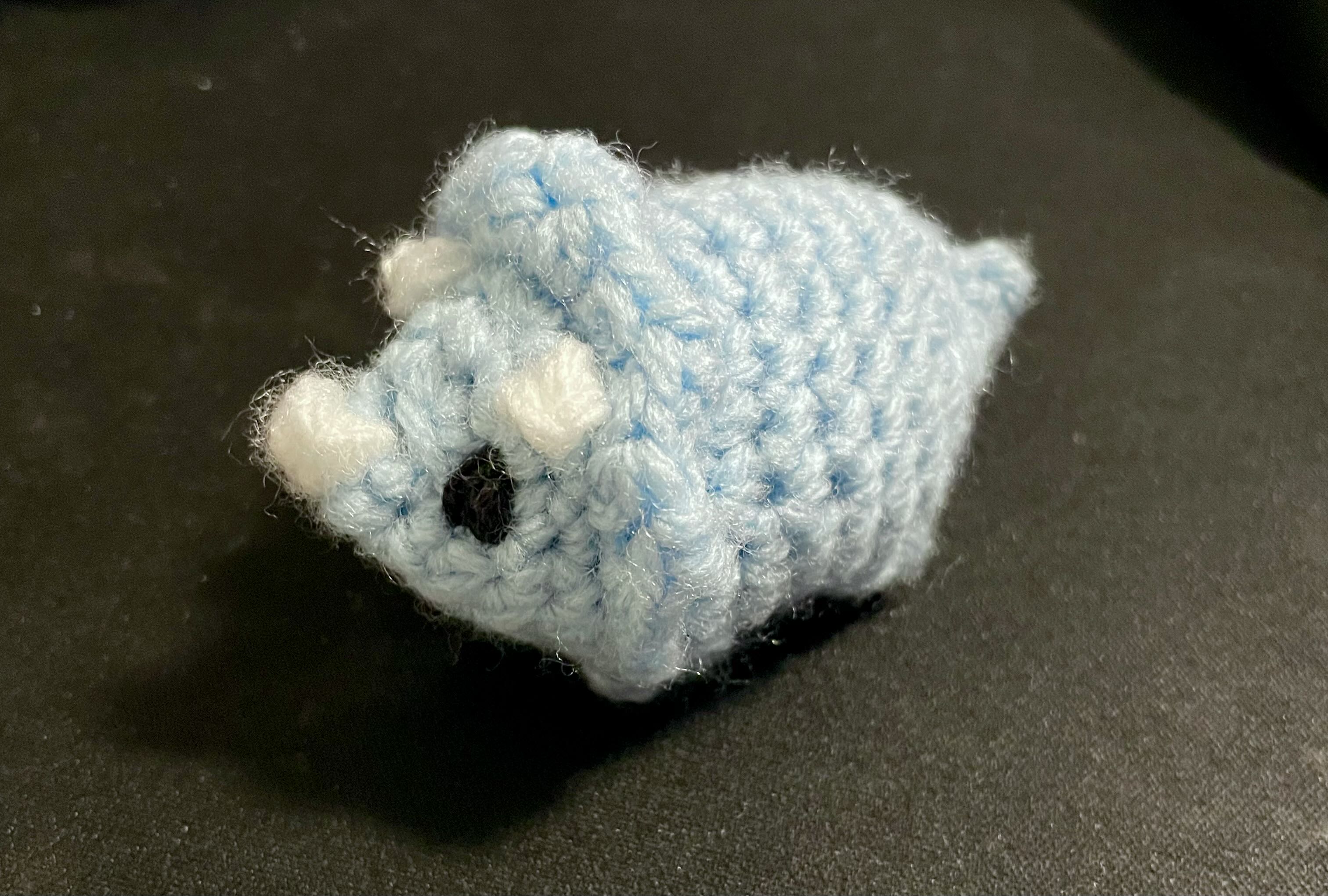 a tiny triceratops crochet plushie